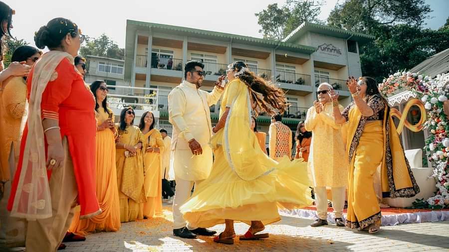 The bride and groom dancing surrounded by people during the day