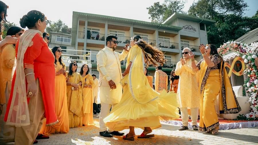 The bride and groom dancing surrounded by people during the day