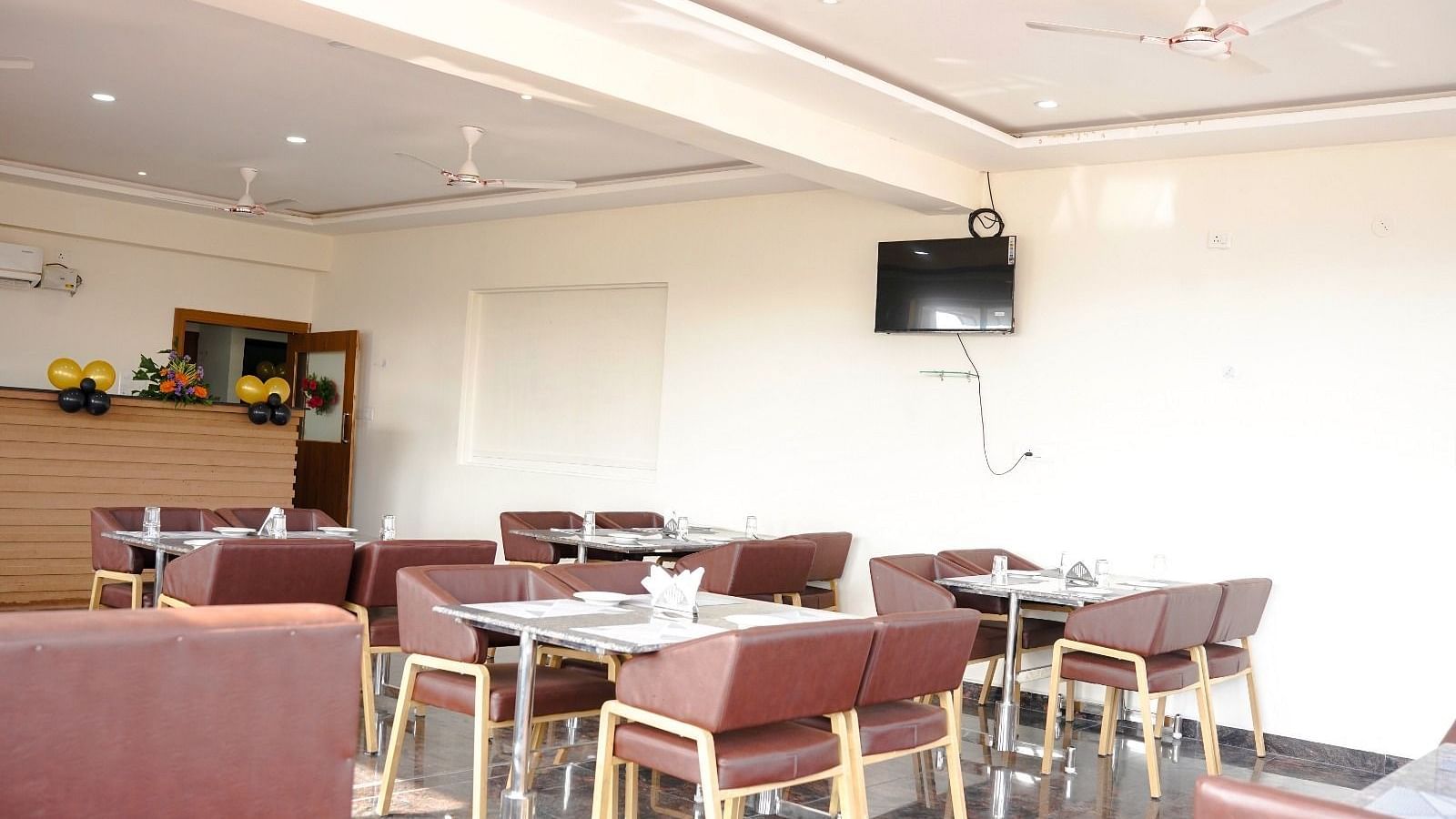 Dining arrangement in a restaurant at ANS M Square Hotel & Resort, Kalaburagi