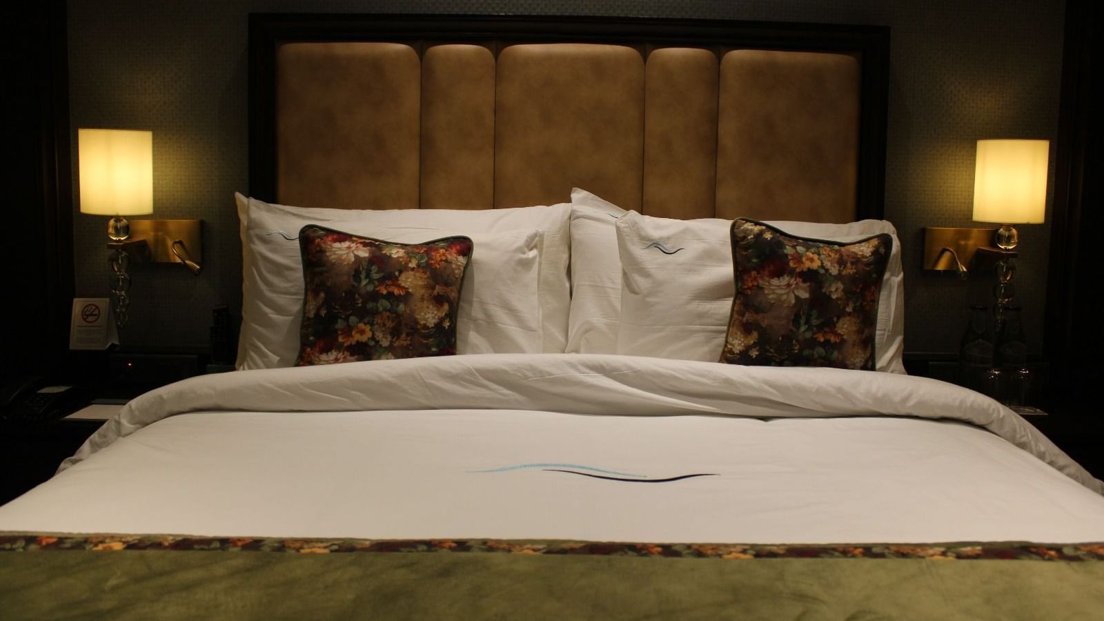 Front view of a neatly made bed with multiple pillows arranged at BluSalzz Residence, Amritsar.
