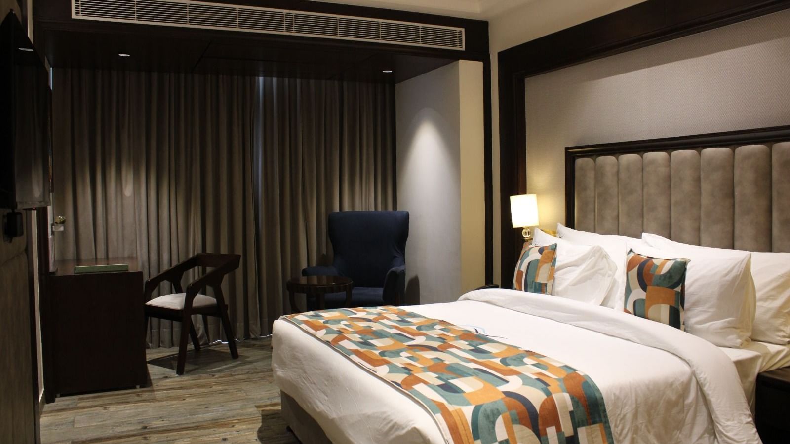 A bedroom featuring working desk and chair at BluSalzz Residence, Amritsar