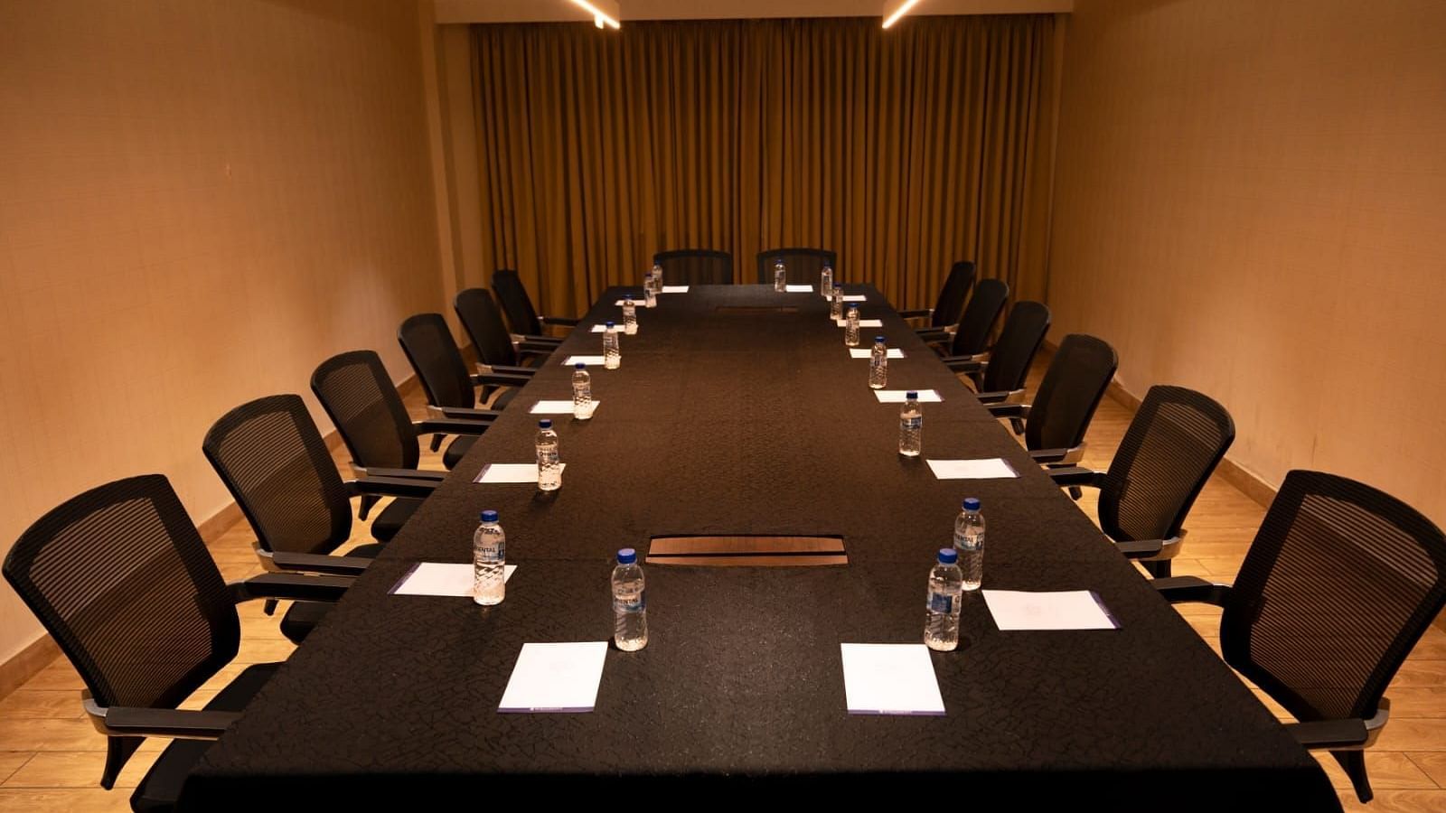 A boardroom with a huge table surrounded by desks at Grand Ashok, Thanjavur.
