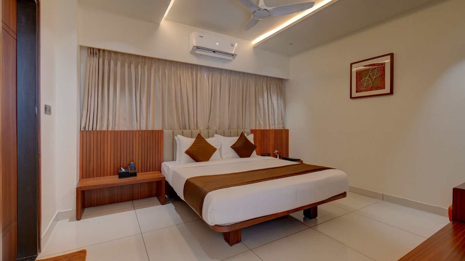 An image of a room at Hari Govindas, Siddappa Square, featuring a bed with an air conditioner mounted above it.