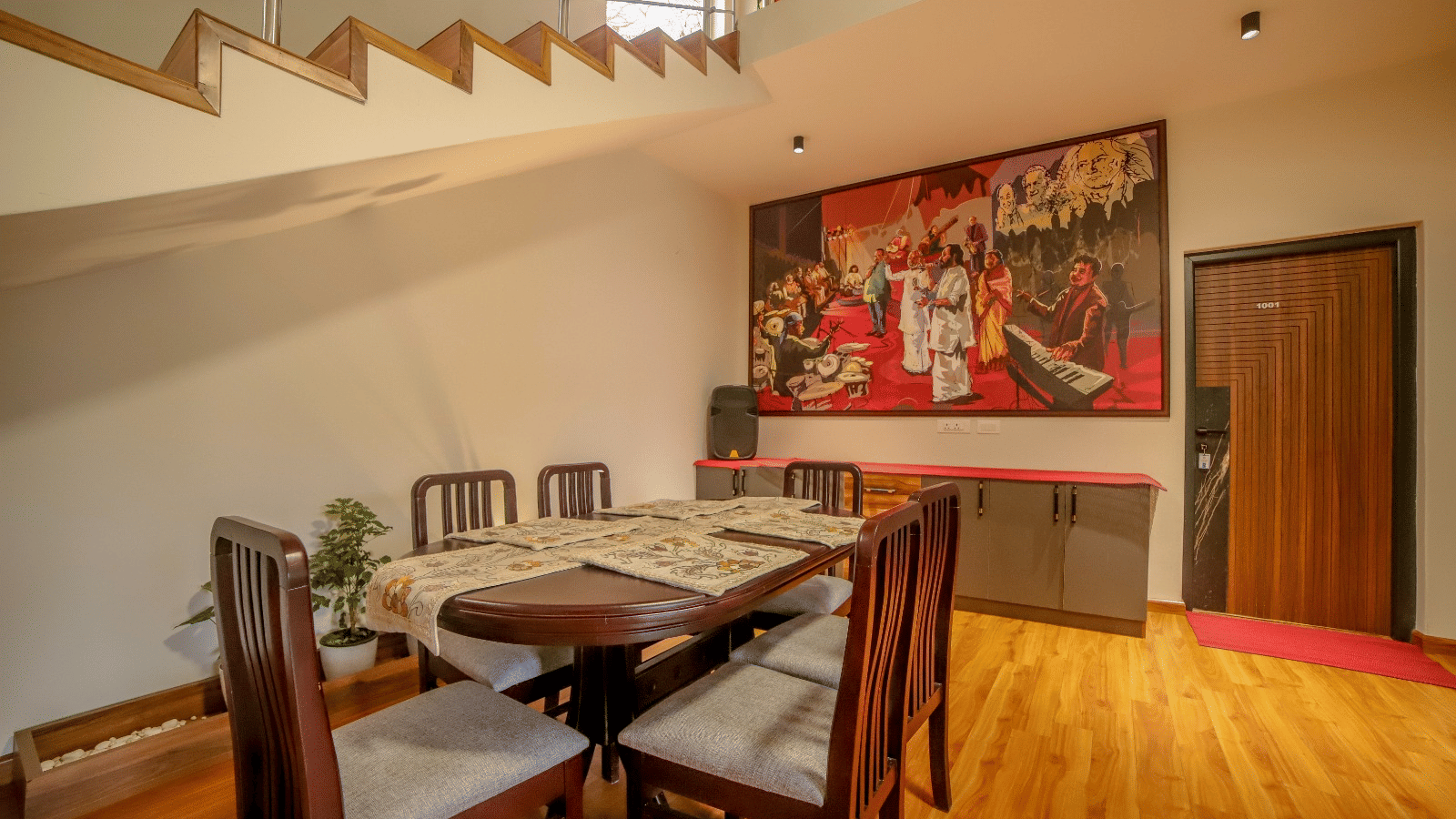 A large wooden table placed in the dining area with wooden flooring at MYST Resorts, Doddabetta, Ooty.
