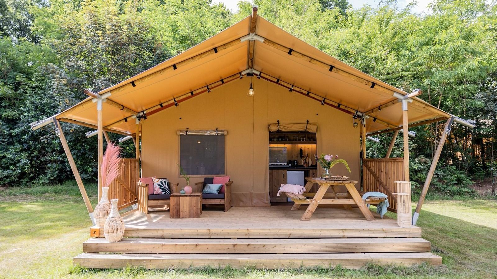An overview of a wooden tent with a private sit out at WoCAL Retreat Ke Ga