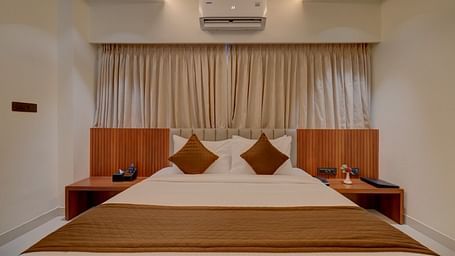 Image of a room with a bed with side tables on both sides at Hari Govindas, Siddappa Square.