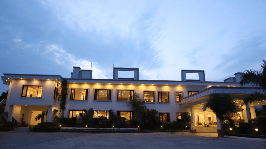 A wide exterior view of A S Hotels, Khajuraho, captured at dusk.