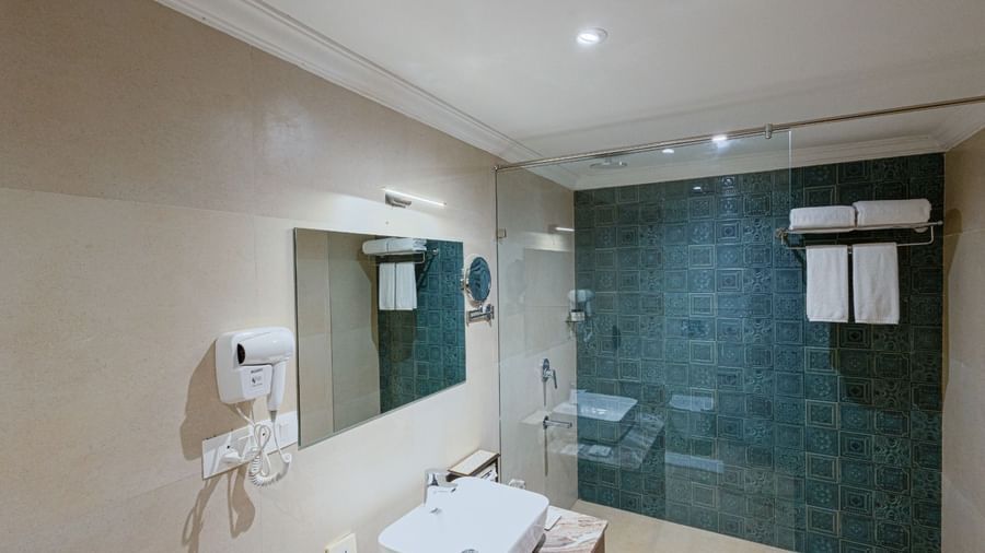 Bathroom at Bamboo Saa Resort & Spa, Udaipur featuring teal patterned tiles in shower area.