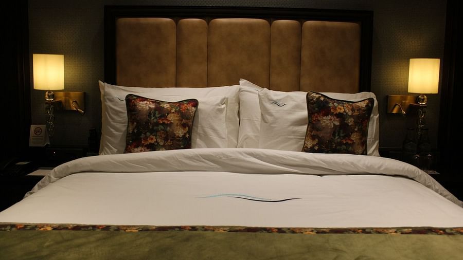 Front view of a neatly made bed with multiple pillows arranged at BluSalzz Residence, Amritsar.