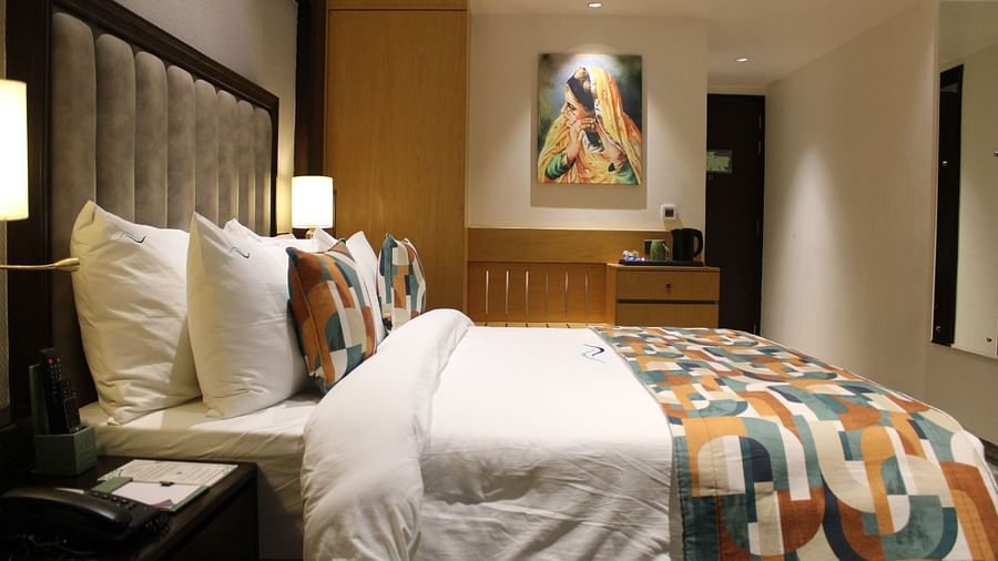 A bedroom with a painting hanging on the wall at BluSalzz Residence, Amritsar.