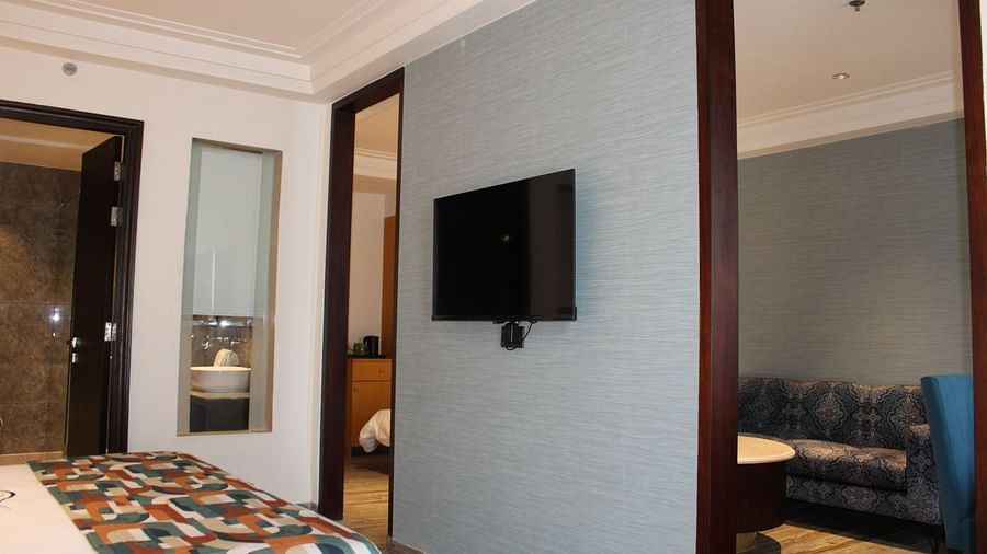 A bedroom with wall mounted television at BluSalzz Residence, Amritsar.