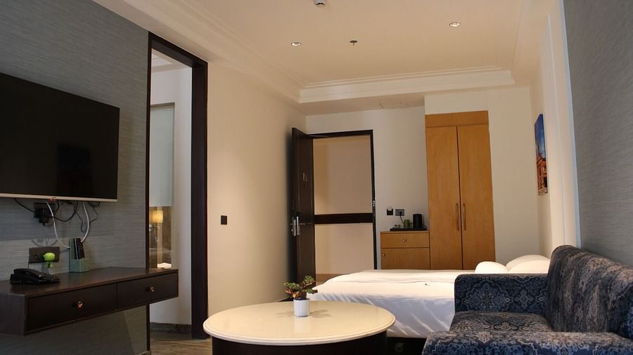 Living space with a wall-mounted TV and a sofa at BluSalzz Residence, Amritsar