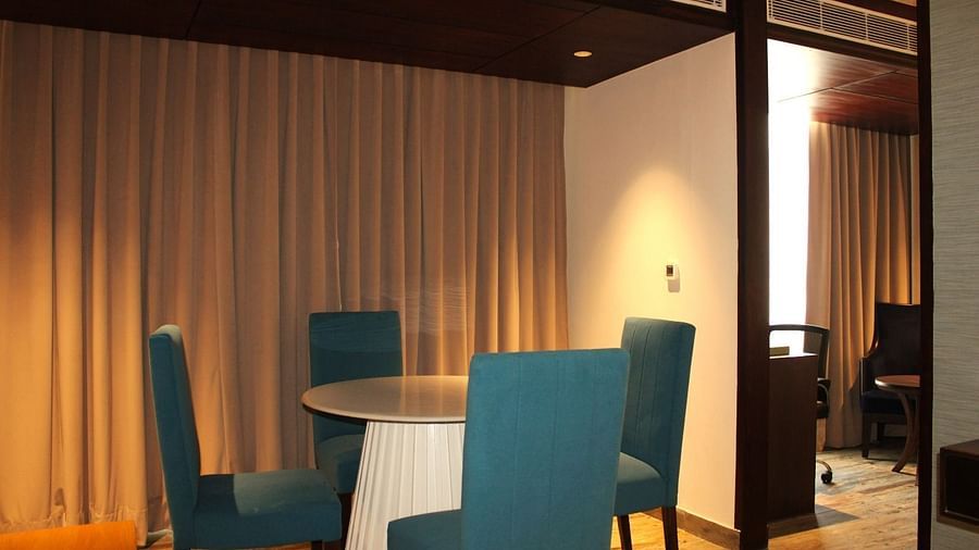 Close-up view of the dining space in the suite featuring a table and chairs at BluSalzz Residence, Amritsar.