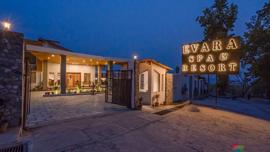 The entrance to Evara Spa & Resort, illuminated at night.