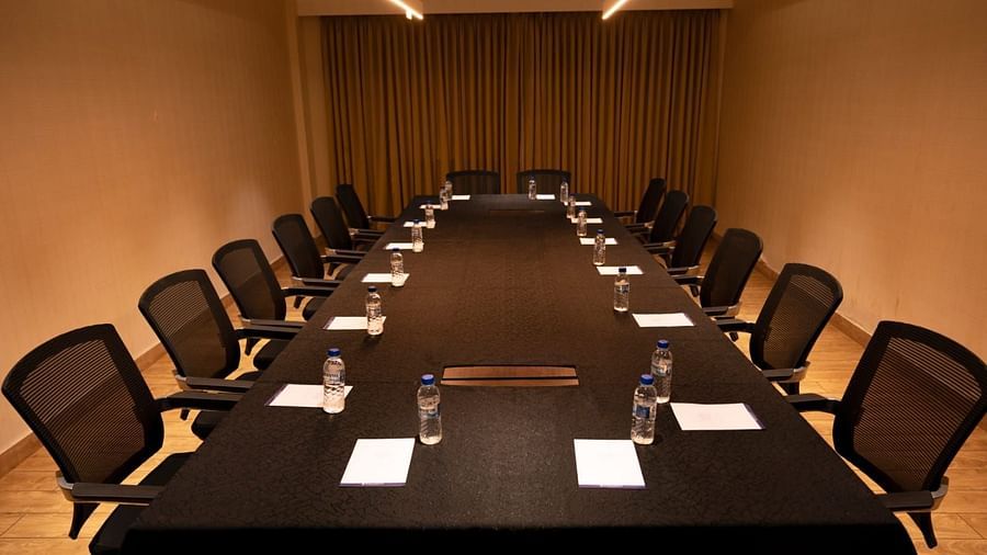 A boardroom with a huge table surrounded by desks at Grand Ashok, Thanjavur.