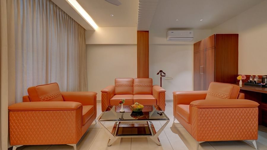 Image of a seating area with sofas and a table in the middle at Hari Govindas, Siddappa Square.
