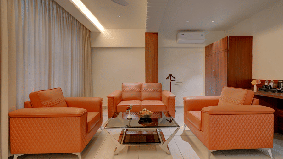 A seating area with sofas and a table in the middle at Hari Govindas, Siddappa Square.