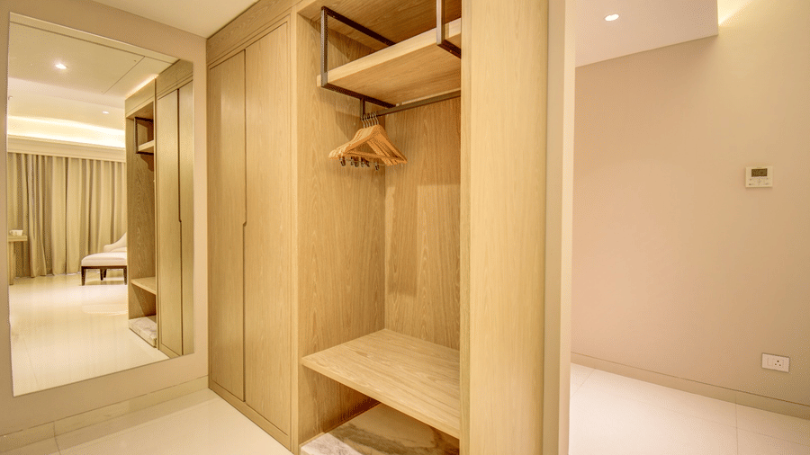 Wardrobe of City View Suite at The SSK Solitaire Hotel and Banquets, Mumbai Naka featuring empty shelves and cloth hangers.