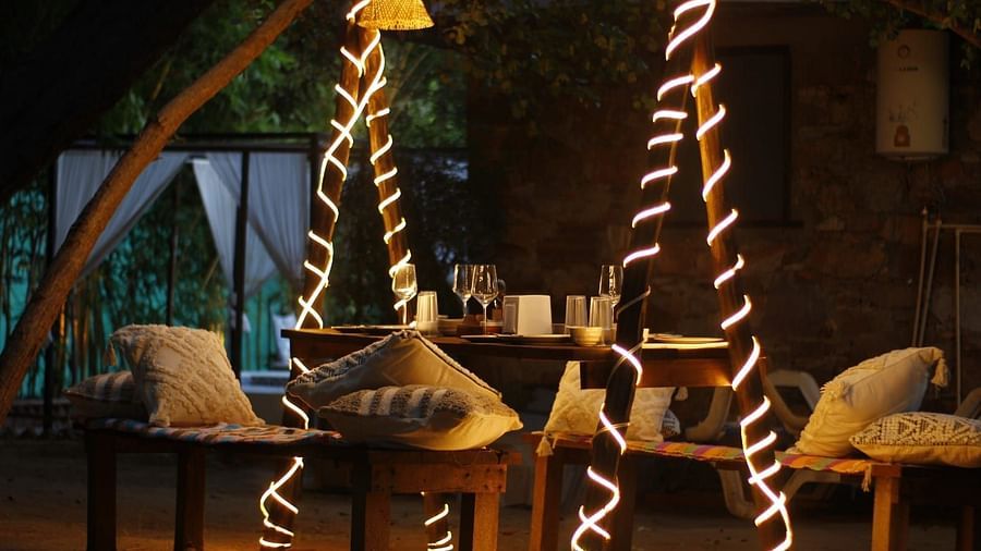 A patio with lights and furnitures decorated with pillows at Valley by Grassfield.