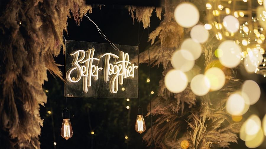 A lighted sign that reads 'Better Together', surrounded by fairy lights and pampas grass decorations Valley by Grassfield.