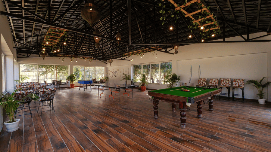 Indoor games room with billiards table at Valley by Grassfield, a family resort in Jaipur.