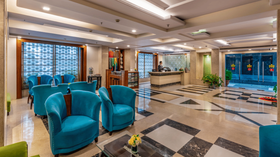 lobby at Libra Lords Inn Jaipur with ample of seating areas, a reception desk, and a boutique display with traditional clothes and jewellery