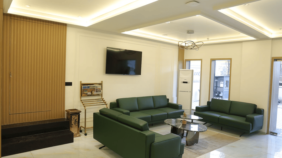 A welcoming reception area at Lords Studio Inn, Jamnagar featuring comfortable seating and a modern aesthetic.