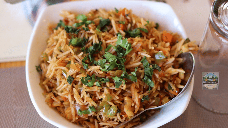 A close-up shot of a bowl of noodles garnished with fresh herbs, served at Dawat e Drung by FrozenFall Resort, Drung, Tangmarg.