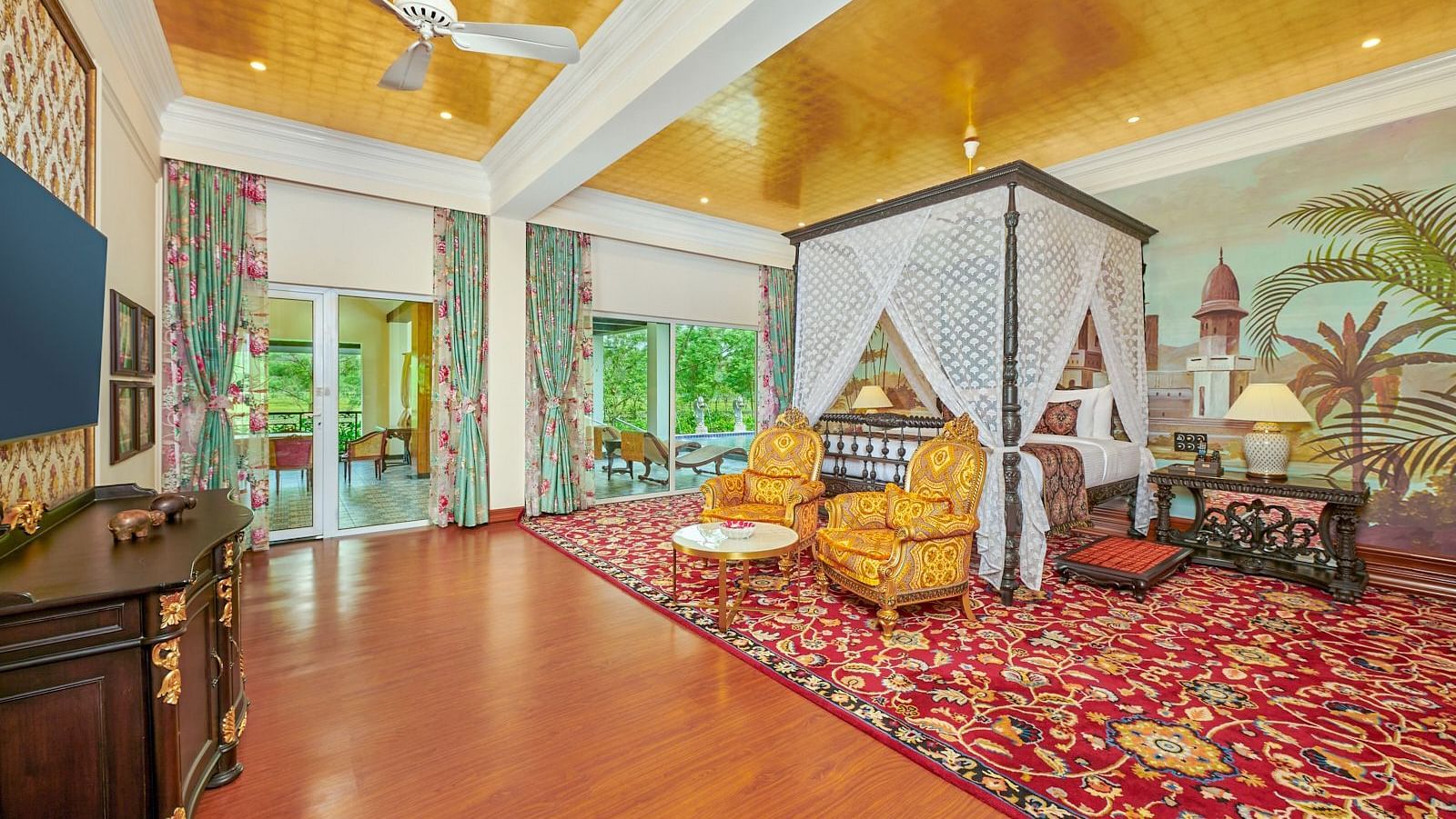 Spacious luxury suite with canopy bed and golden ceiling at MAYFAIR Tea Resort, Siliguri