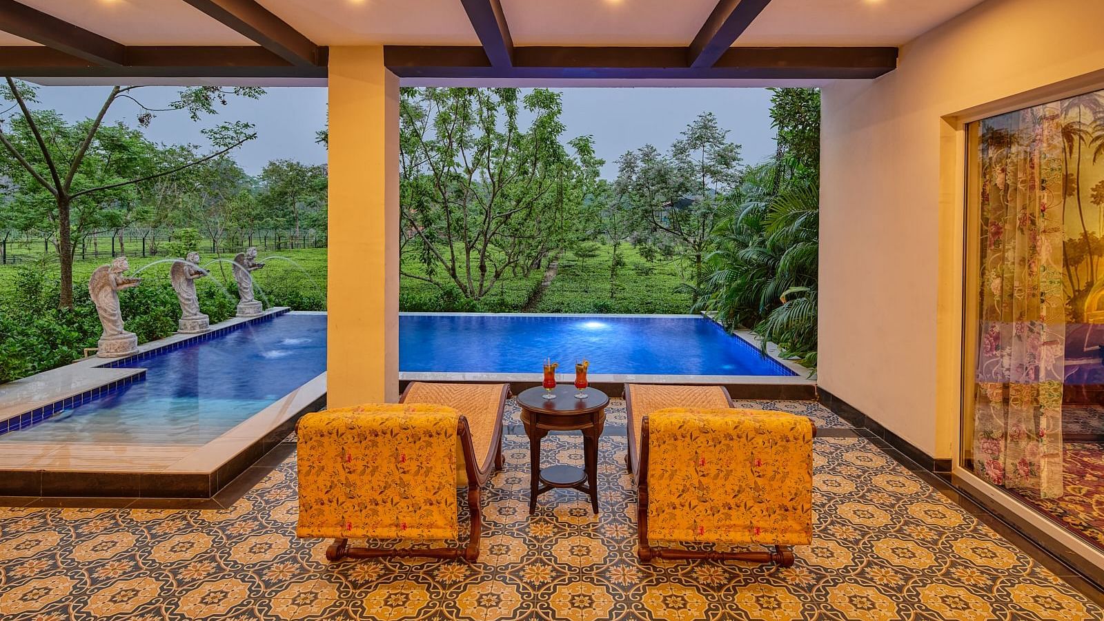 Poolside view from luxury suite with outdoor seating at MAYFAIR Tea Resort, Siliguri