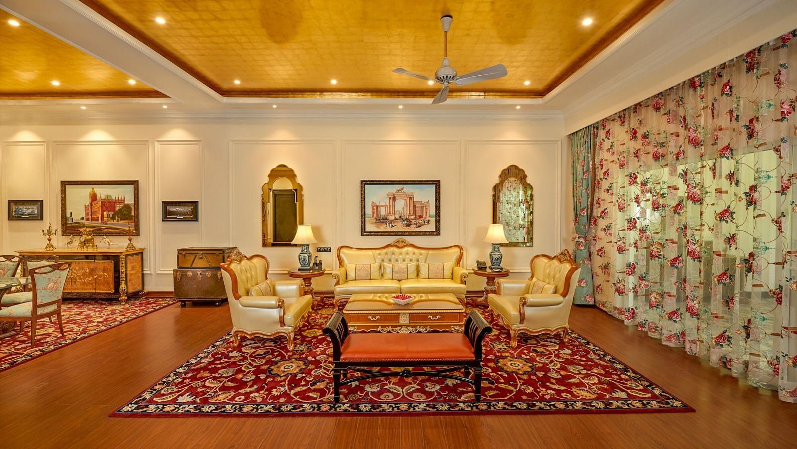Luxurious Colonial  Room with elegant seating, chandelier lighting, and traditional decor.