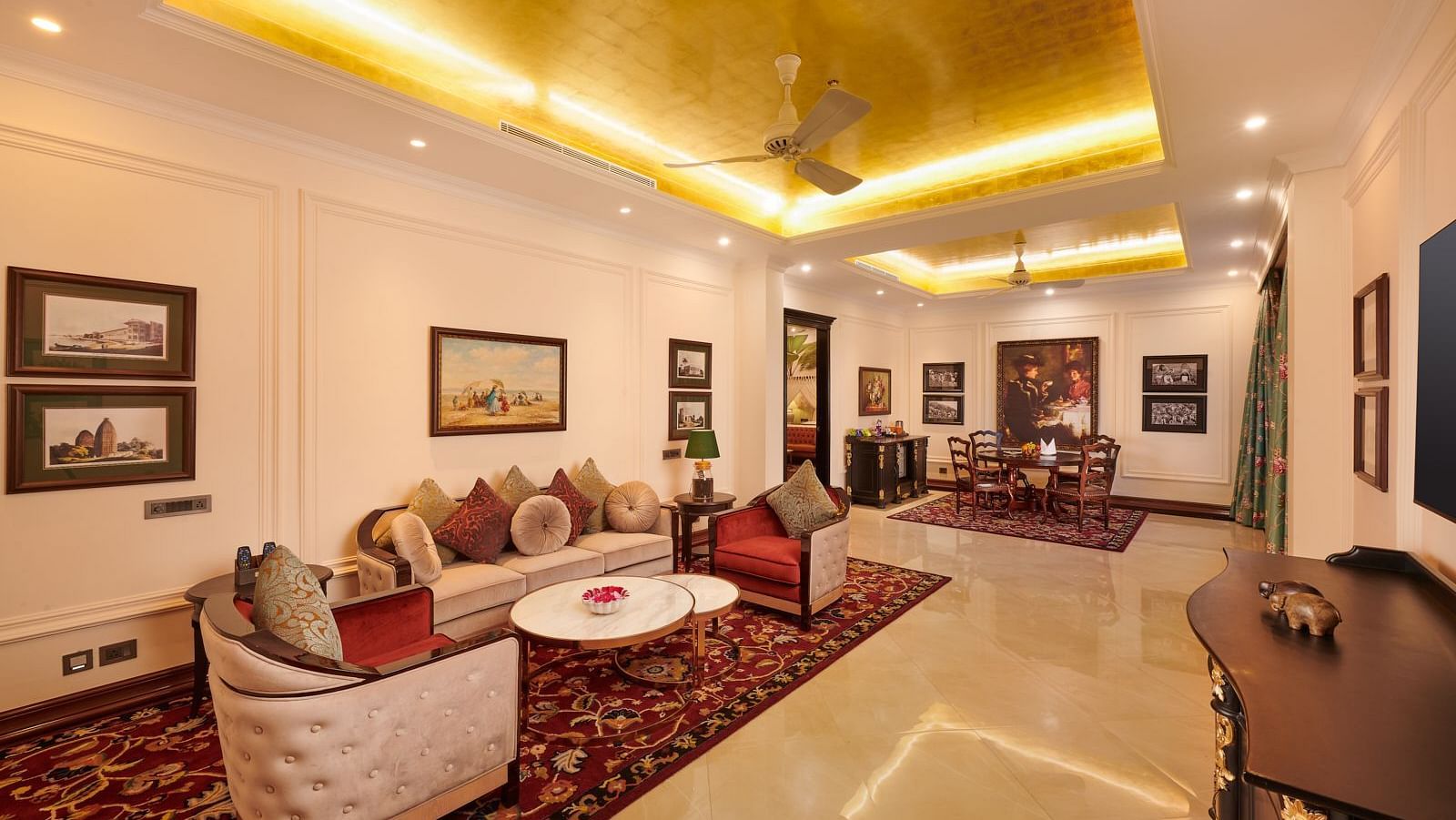 Luxurious living area with golden ceiling and plush seating at MAYFAIR Tea Resort, Siliguri