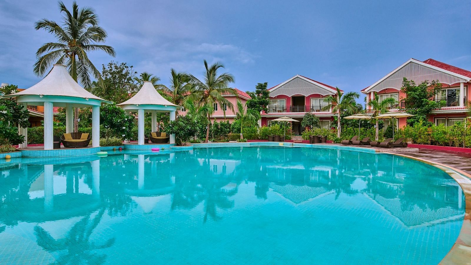 Swimming pool area of Swosti Chilika Resort during the day