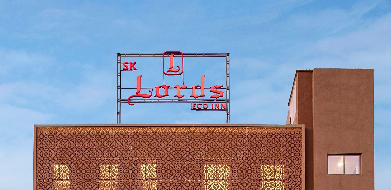 An exterior view of a modern, multi-storey hotel building - SK Lords Inn Ahmedabad