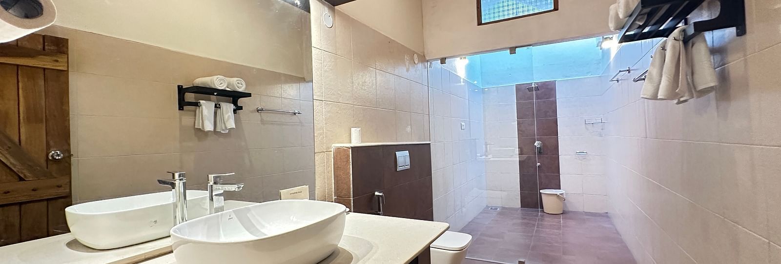 a bathroom with a washbasin and a western style toilet - Kadkani River Resort, Coorg