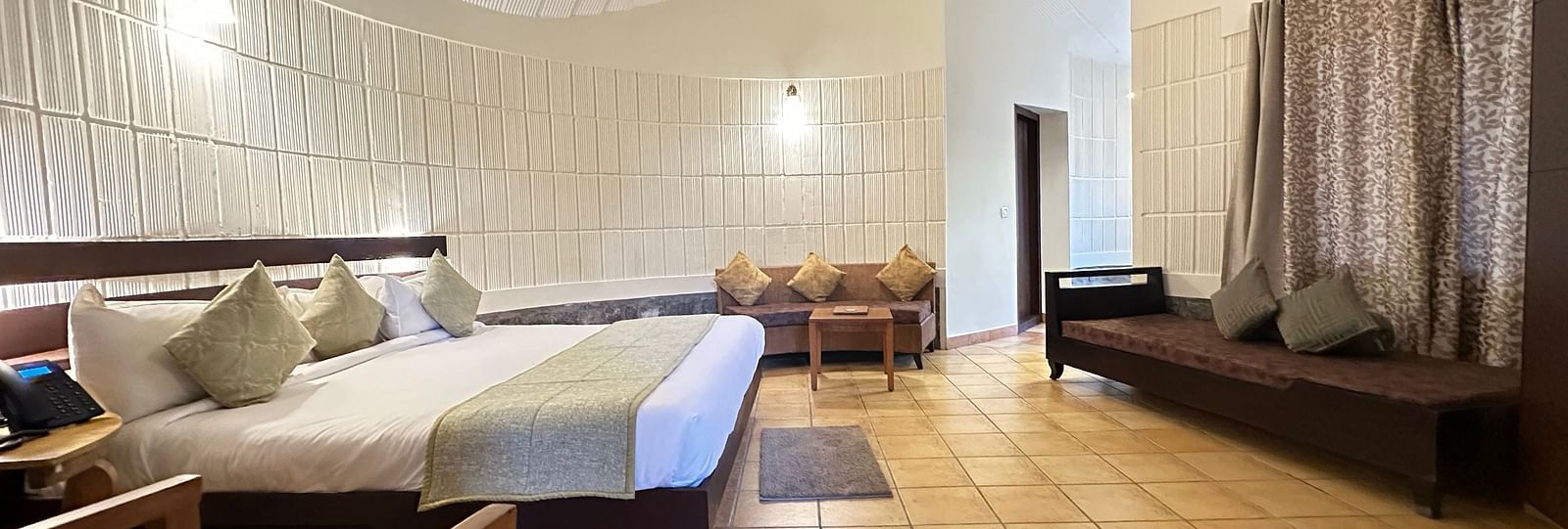 a bedroom with a double bed and a single bed opposite to it, with chairs in the room - Kadkani River Resort, Coorg