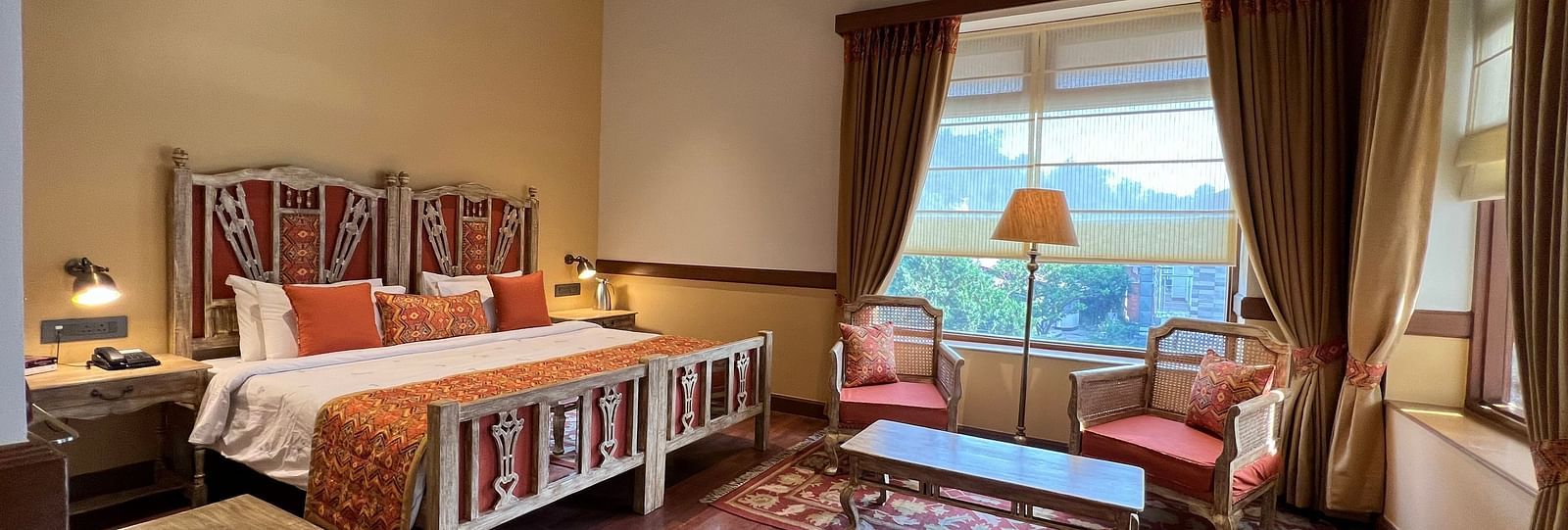 A interior view of Superior Lake Facing Rooms with wooden flooring and a huge window - Leisure Hotels