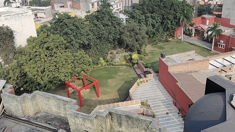 Drone shot of Hotel Gold panipat featuring the rooftop overlooking the lawn and the city landscape.