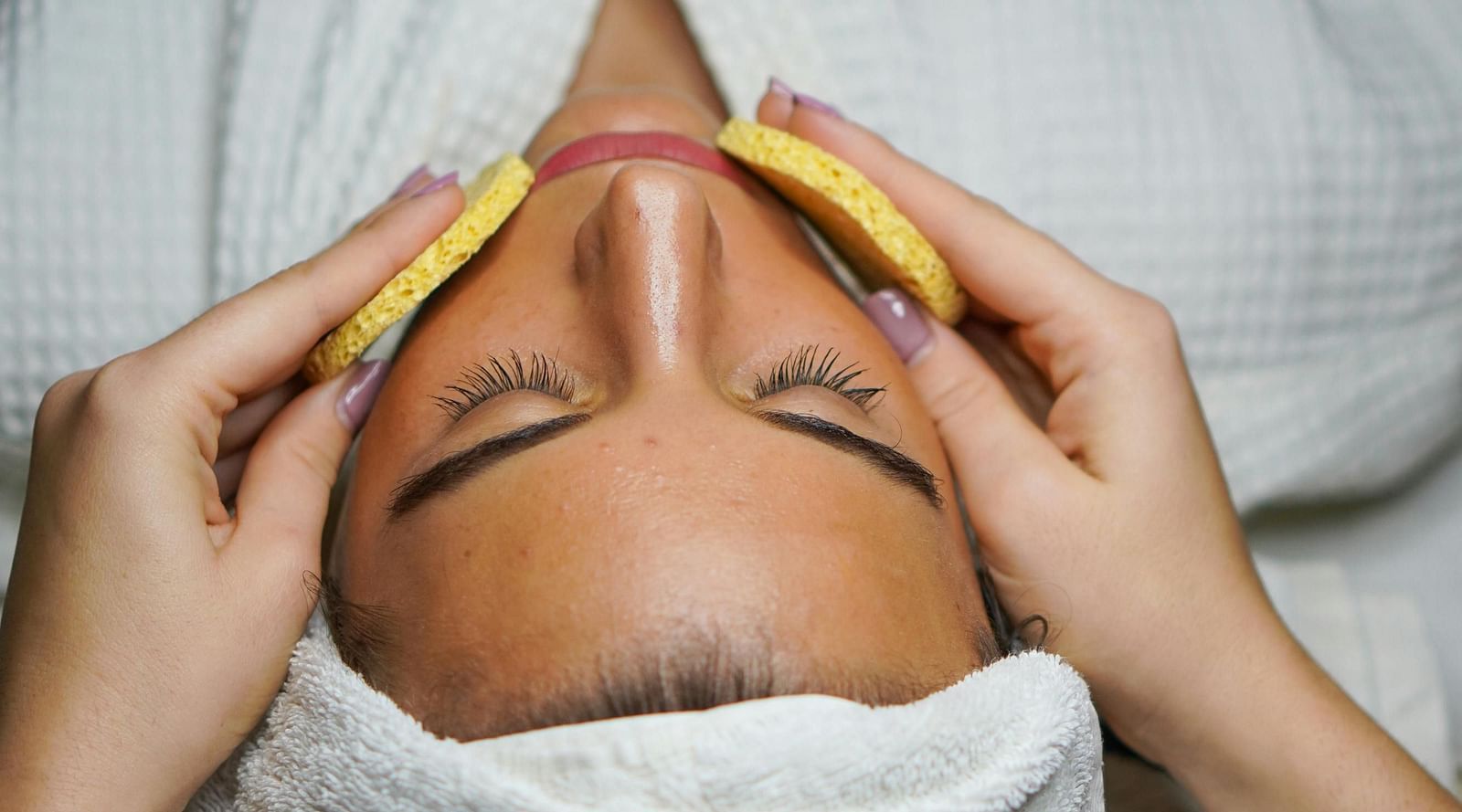 An image of a women getting a facial spa treatment