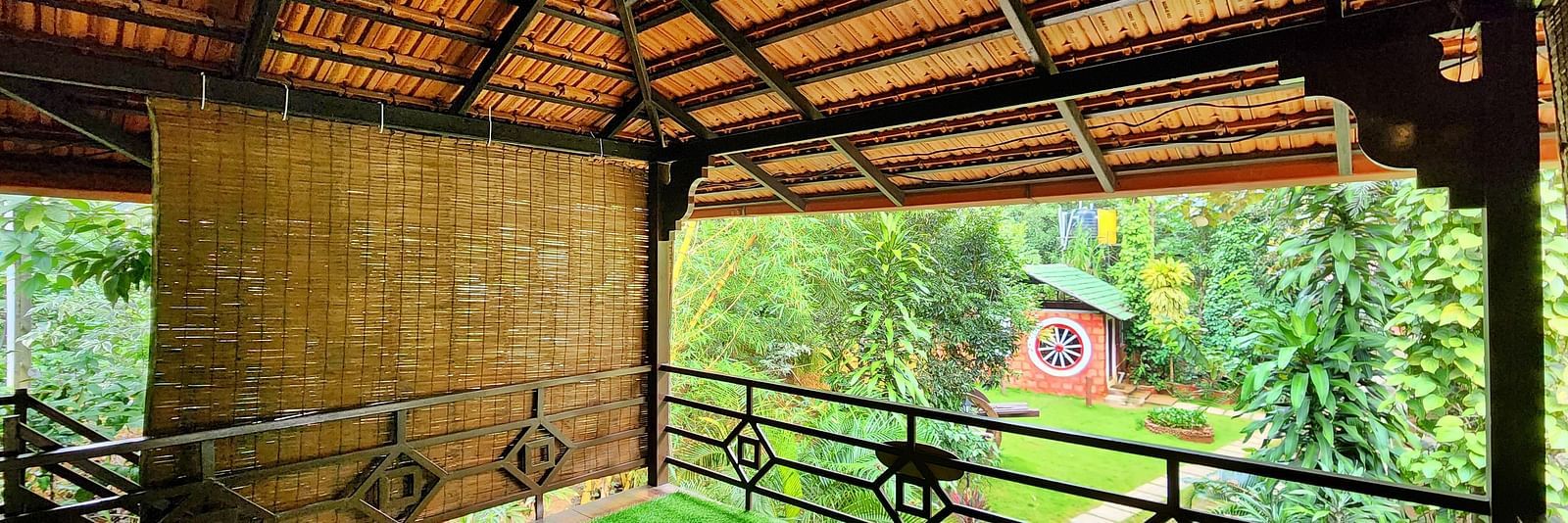 A balcony in the Group Wooden Cottage overlooking the lush greenery - Evergreen County