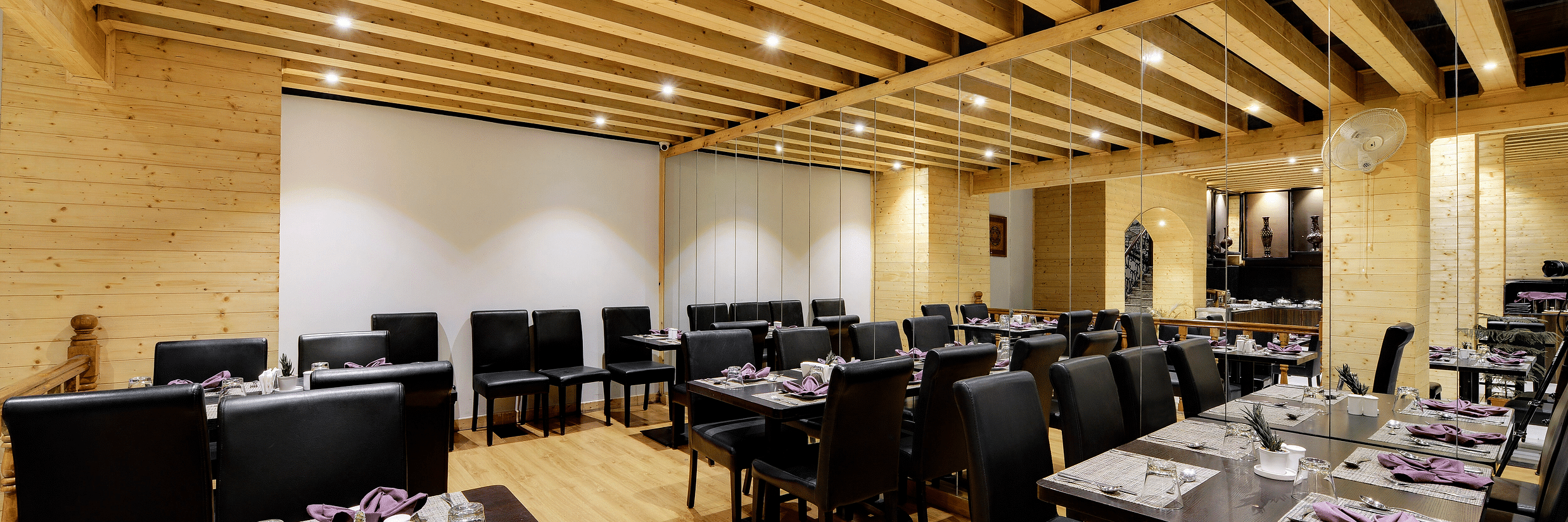 overview of the seating arrangements inside blue charcoal Restaurant - Sumitel Shangrila, Deorali
