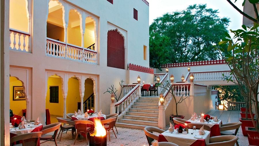 Outdoor seating arrangement at anada restaurant in the evening - Mandawa Haveli, Jaipur