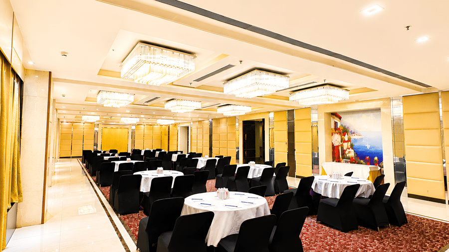 Hotel elevator lobby at Golden Tulip Kukas Jaipur with marble wall cladding, lift doors, and soft ambient lighting.