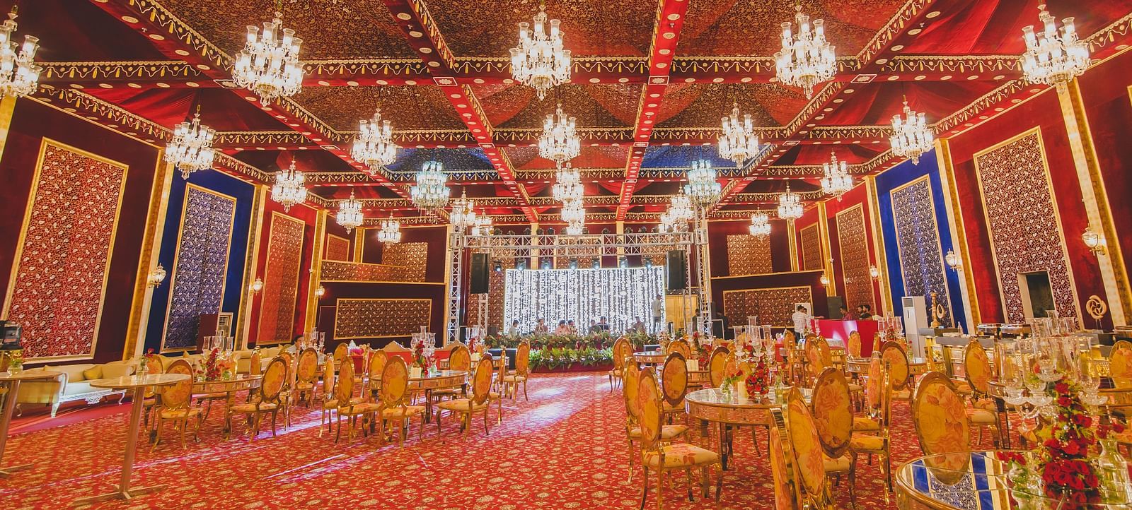 Image of Swarn Mahal with chairs and tables and chandeliers hanging from the ceiling at Rajasthali Resort & Spa Jaipur.