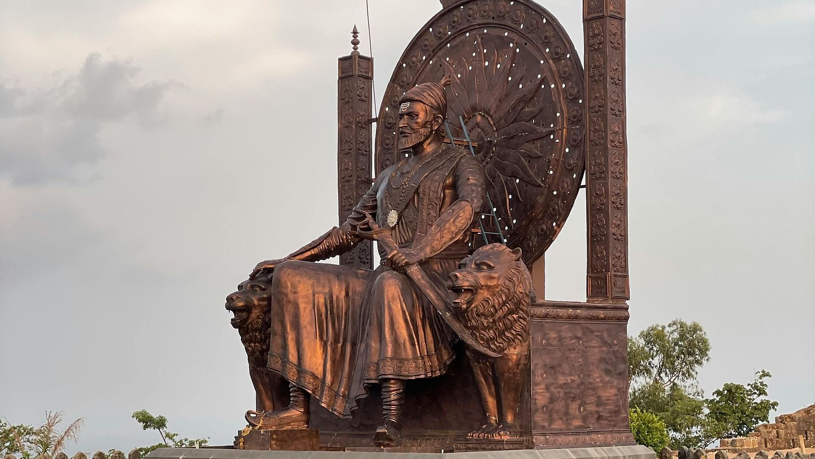 Bronze statue of Chattrapati Shivaji Maharaj sitting in the emperor's throne, which is decoratively placed at a height to engage the travellers.