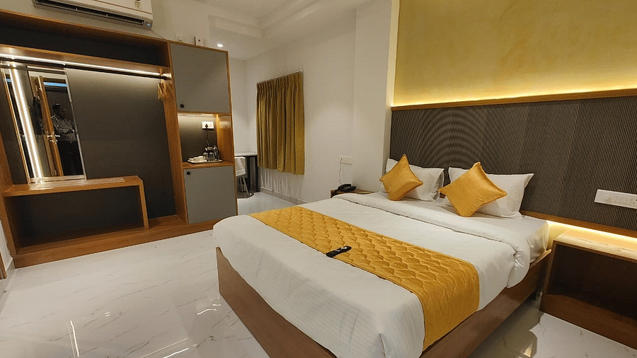 a view of the king sized bed of room at hotel La Premier 