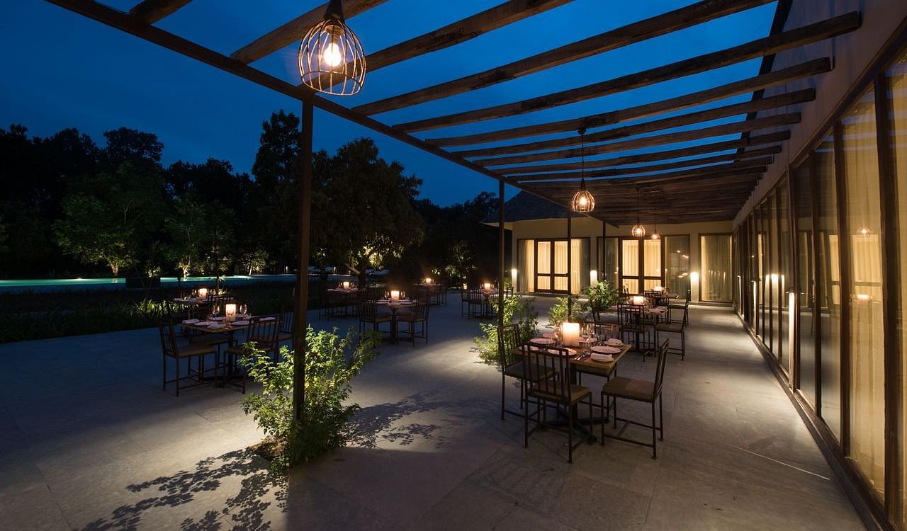 Outdoor dining arrangement at a restaurant at Saraca Resort & Spa Corbett