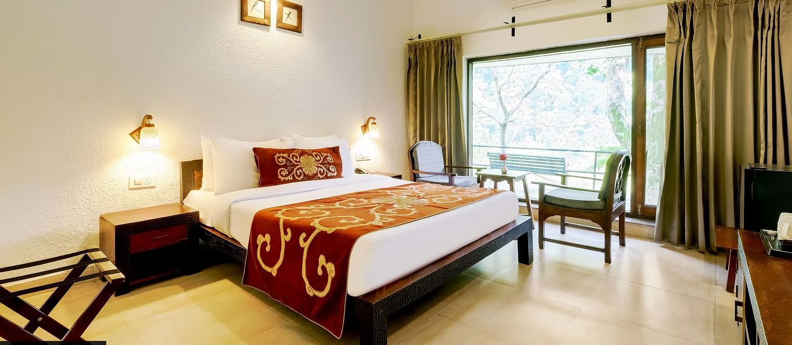 Image of a room with bed and large windows at Summit By The Ganges Beach Resort & Spa, Rishikesh