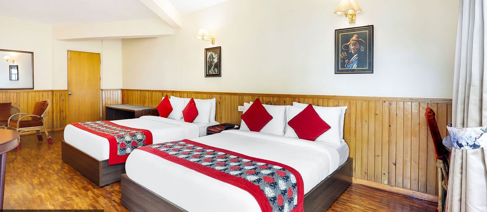 A side view of two beds in a room | Summit Newa Regency & Spa, Pelling