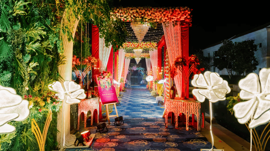 Decorated event entrance at Marasa Sarovar Premiere, Bodhgaya featuring illuminated floral decor, draped fabrics, and a patterned walkway